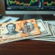 Chinese yuan and US dollar banknotes on a desk representing forex market analysis