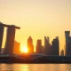 Sunrise over Singapore's Marina Bay financial district with clear sky