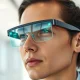 Person wearing Even Realities G2 smart glasses with green heads-up display visible in lenses