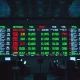 Forex trading board showing US dollar currency pairs on a trading floor