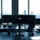Quiet Tokyo forex trading desk with USD/JPY charts on monitors during US Independence Day holiday