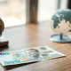 Mexican peso banknote on desk with North America model in background