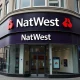 Exterior of a NatWest bank branch in London's financial district on a cloudy day