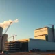 Construction site at a modern nuclear power plant at dawn, symbolizing new investment