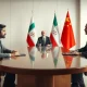Diplomatic meeting between Pakistan and Iran officials with Chinese mediator at a conference table