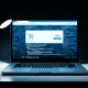 Laptop screen showing a shopping browser extension interface with digital tracking elements in the background.