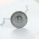 Silver bullion coin on financial chart with upward trend line