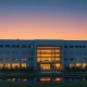 Exterior view of a semiconductor facility in Taiwan at dusk, representing the AI chip supply chain.