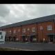 Newly built UK homes with a For Sale sign under overcast sky