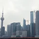 Shanghai skyline on a cloudy day, representing China's economic challenges