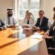 A wealthy Middle Eastern family meeting with a lawyer in a London law office to discuss a sharia-lite will.