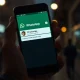 Smartphone showing WhatsApp username interface with a potentially impersonating handle