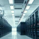 Interior view of a modern AI data center with high-density server racks and power conversion equipment.
