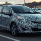 A 2009 Toyota Yaris covered in a geometric adversarial pattern designed to evade surveillance camera detection, displayed at Def Con 2026.