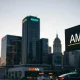 Financial district skyline with stock ticker showing AMZN, representing institutional investor activity