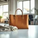 Italian leather handbag and sweater displayed in Atoire's bright startup studio