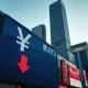 Currency exchange board showing yen symbol with downward arrow in Tokyo financial district