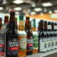Assorted craft beer bottles and hard seltzer cans on a store shelf, representing Boston Beer's portfolio.