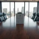 Empty corporate boardroom table with a legal document folder, representing the DOJ probe into Andreessen Horowitz board seats.