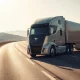 Tesla Semi electric truck driving on a highway, representing Einride's fleet expansion