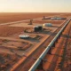Aerial view of crude oil gathering pipelines and storage tanks in the Permian Basin's Delaware Basin region.