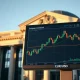 EUR/USD trading chart on a monitor in front of the European Central Bank building in Frankfurt