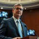 FCC Chairman Brendan Carr speaks at a podium in a hearing room