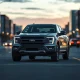 Ford Fathom compact electric pickup truck parked on a city street at dusk