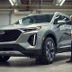 Technician inspecting the brake system of a GM electric SUV in a dealership service bay