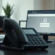 A desk phone in a financial office, symbolizing vishing attacks on investment firms.
