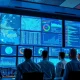 Security analysts monitoring network activity in a modern operations center