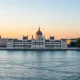 Hungarian Parliament Building in Budapest at dawn, symbolizing the country's economic outlook.