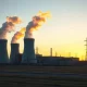 Natural gas power plant with cooling towers at dusk, representing energy infrastructure for AI data centers