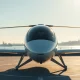 Joby Aviation eVTOL aircraft on a helipad with a city skyline in the background