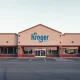 Exterior of a Kroger supermarket with an empty parking lot, illustrating recent store closures