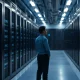 Inside a modern data center with server racks and a person in the foreground, representing Meta's AI infrastructure.