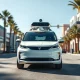 Autonomous robotaxi driving on a sunny city street