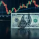 New Zealand Dollar coin and US Dollar banknote on a trading desk
