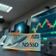 New Zealand Dollar banknote and NZD/USD chart on a trading desk