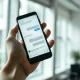 Smartphone showing ChatGPT interface with an ad card, representing OpenAI's ad rollout in India
