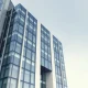 Modern corporate office building exterior, representing OpenAI's headquarters, in a news context.