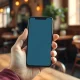 Person using a read-it-later app on a smartphone in a coffee shop