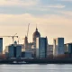 Warsaw skyline with construction cranes, symbolizing Poland's economic growth and investment rebound