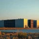 Large data center facility at dusk in a Midwestern landscape