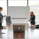 Two business professionals in a meeting room, representing the Runlayer-Rippling legal dispute