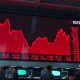 Stock market board showing red declining charts during a trading session