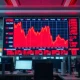 Stock market display showing red declining charts during a selloff