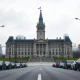 Parliament Building in Ottawa under overcast sky, representing Canada's economy amid US trade tariffs.