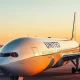 United Airlines Boeing 777-200ER aircraft parked at airport gate during golden hour