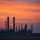 Aerial view of an oil refinery at sunset, representing Iran's energy infrastructure.